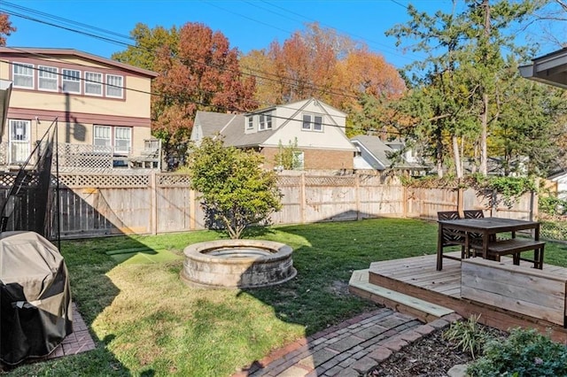 view of yard with an outdoor fire pit and a wooden deck