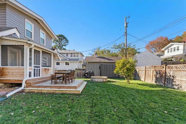 view of yard with a deck and a sunroom