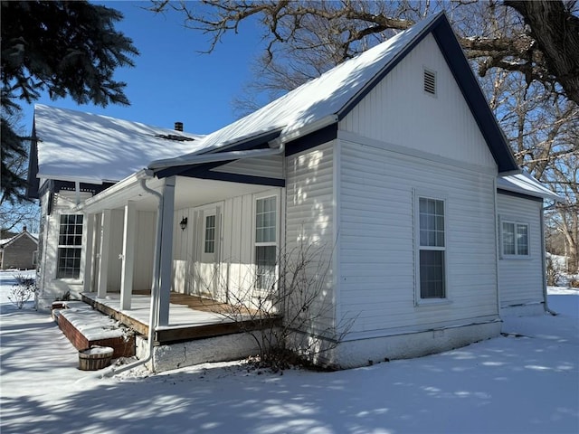 view of snow covered exterior featuring covered porch