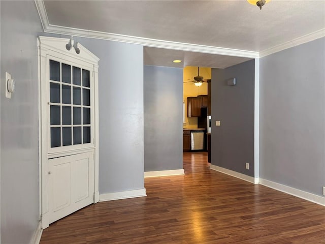 empty room featuring dark hardwood / wood-style floors, ceiling fan, and ornamental molding