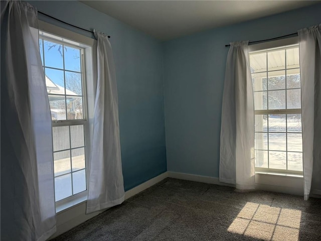 unfurnished room featuring carpet flooring and a wealth of natural light