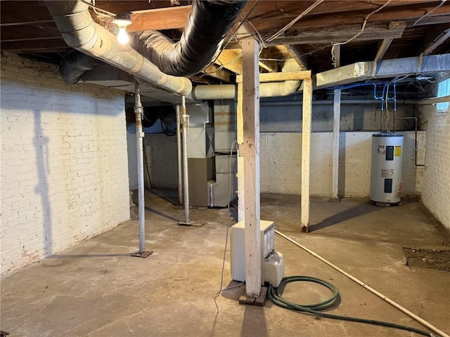 basement with electric water heater and heating unit