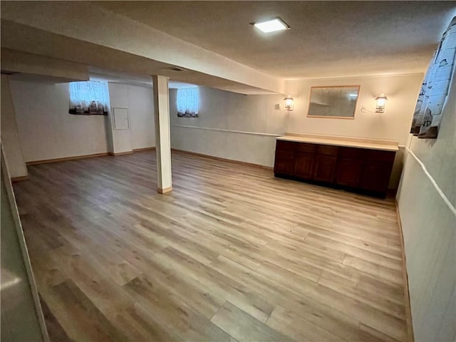 basement with light hardwood / wood-style floors