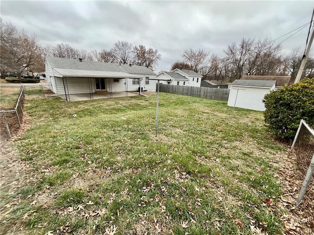 view of yard featuring a patio and a storage shed