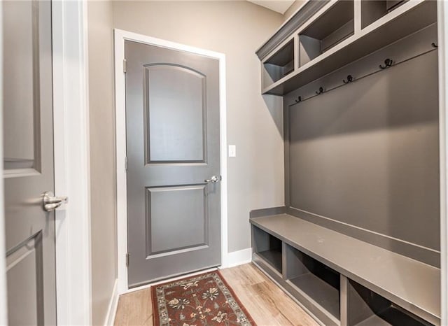 mudroom with baseboards and light wood-style floors