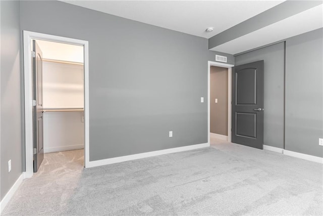 unfurnished bedroom with a closet, baseboards, and carpet