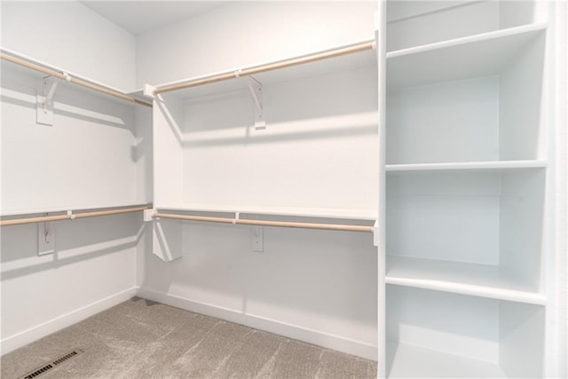 spacious closet featuring visible vents and carpet floors