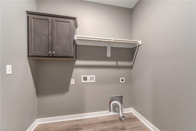 washroom with electric dryer hookup, wood finished floors, cabinet space, baseboards, and hookup for a washing machine