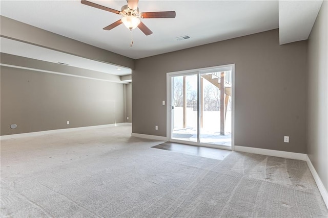 unfurnished room with baseboards, visible vents, carpet floors, and ceiling fan