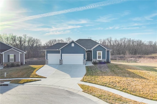 ranch-style house featuring stone siding, an attached garage, concrete driveway, and a front yard