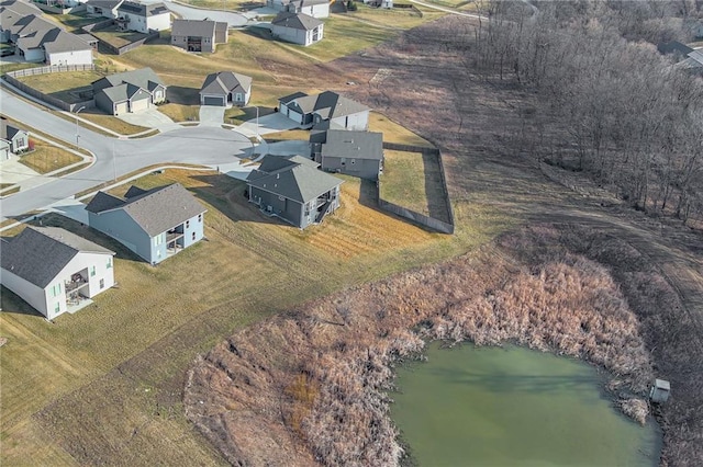 drone / aerial view featuring a residential view and a water view