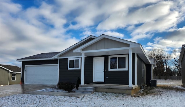 view of front of property with cooling unit and a garage