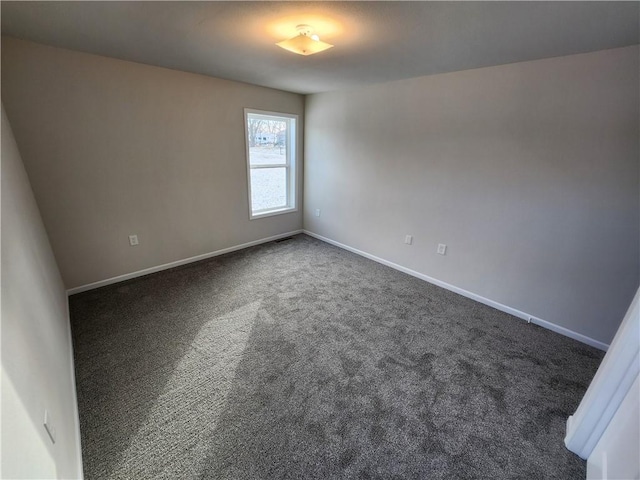 unfurnished room with dark colored carpet