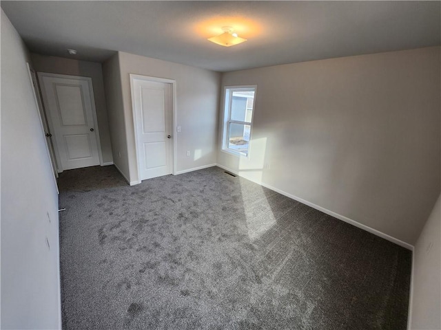 unfurnished bedroom featuring dark colored carpet