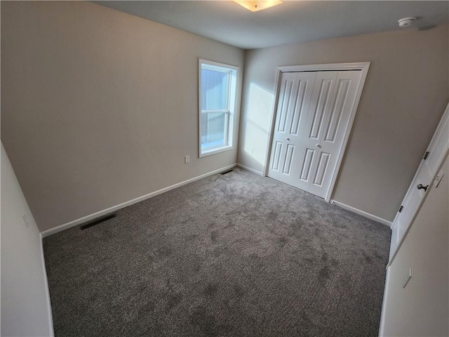 unfurnished bedroom featuring a closet and carpet floors