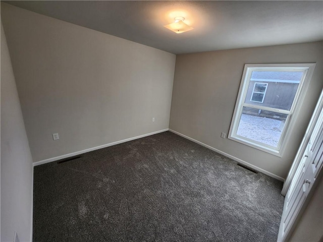 empty room with dark carpet