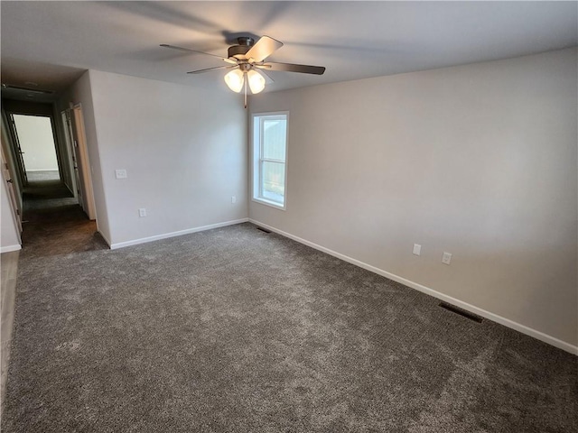 carpeted spare room with ceiling fan