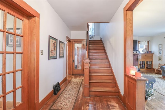 stairs featuring wood-type flooring