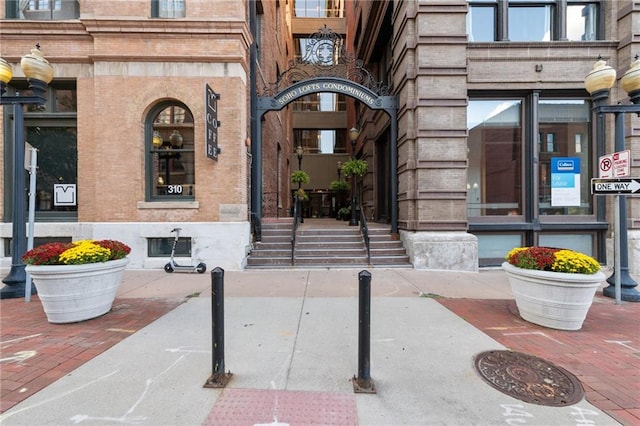 doorway to property with brick siding