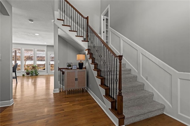 staircase with wood-type flooring