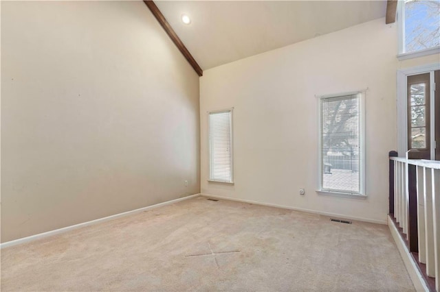 empty room with high vaulted ceiling, beam ceiling, and light carpet