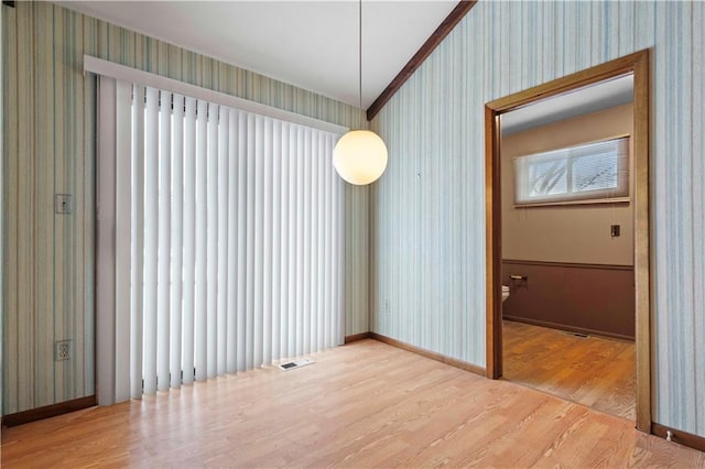 interior space featuring wood-type flooring and ornamental molding