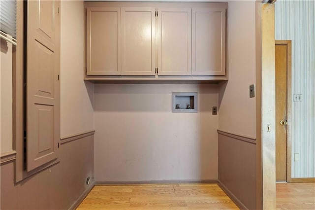 laundry room featuring light wood-type flooring, washer hookup, electric dryer hookup, and cabinets