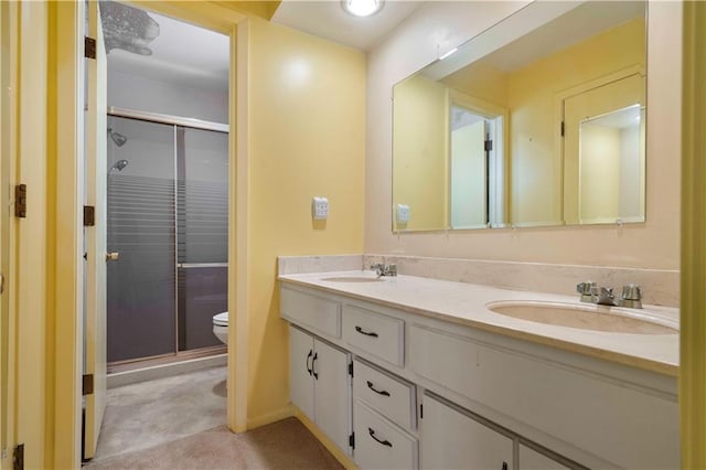 bathroom featuring toilet, walk in shower, and vanity