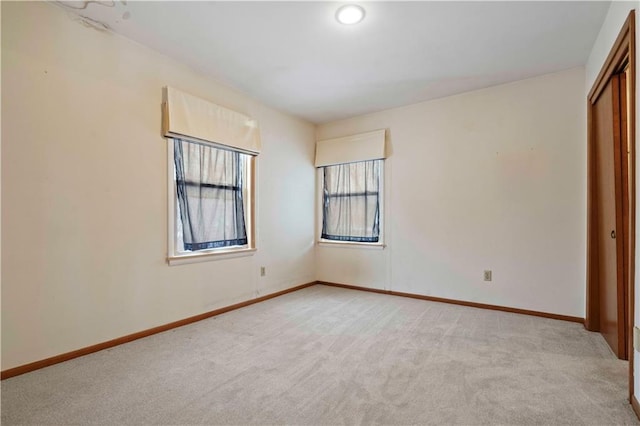 unfurnished bedroom featuring a closet and light carpet