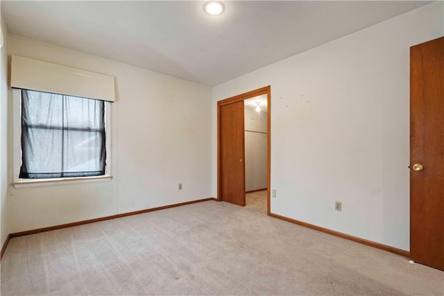 spare room with light colored carpet