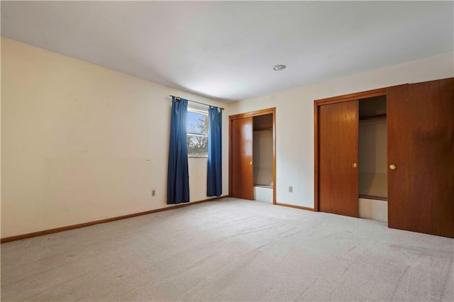 unfurnished bedroom featuring light colored carpet