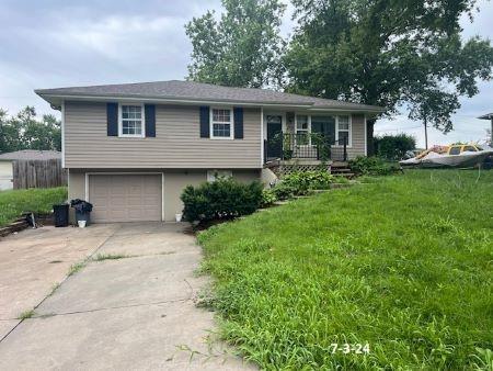 view of front of property with a front yard and a garage