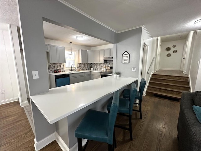 kitchen with dishwashing machine, pendant lighting, stainless steel range with electric cooktop, kitchen peninsula, and gray cabinetry