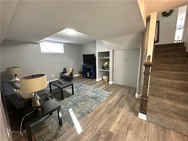 living room featuring hardwood / wood-style flooring and a textured ceiling