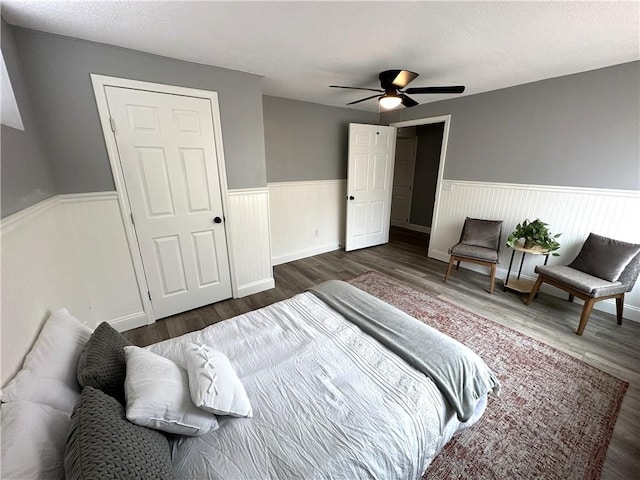 bedroom with ceiling fan and dark wood-type flooring