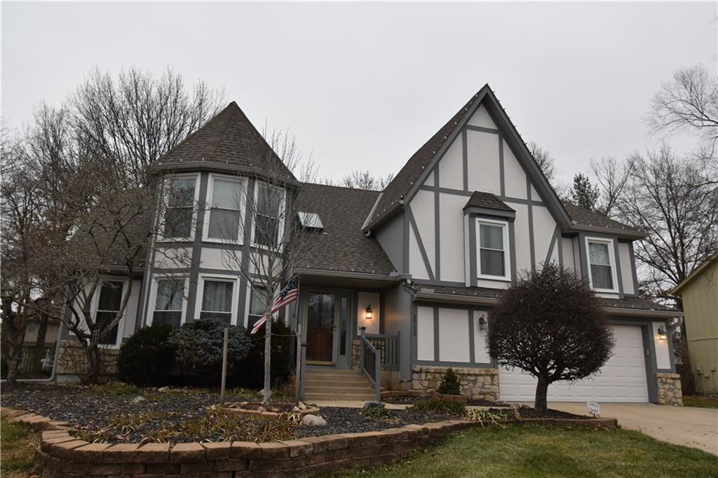 tudor house featuring a garage