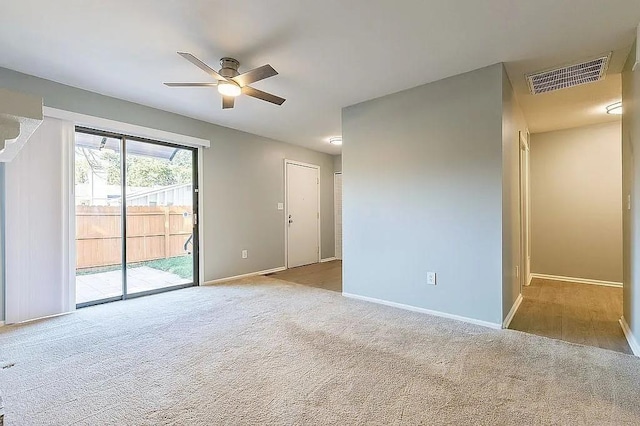 carpeted spare room featuring ceiling fan