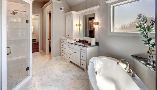 bathroom featuring vanity and shower with separate bathtub