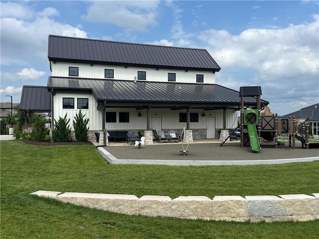 back of property with a playground, an outdoor living space, a lawn, and a patio