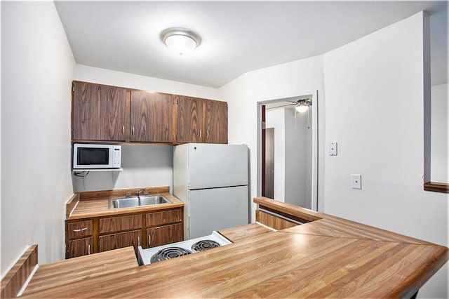 kitchen with sink and white appliances