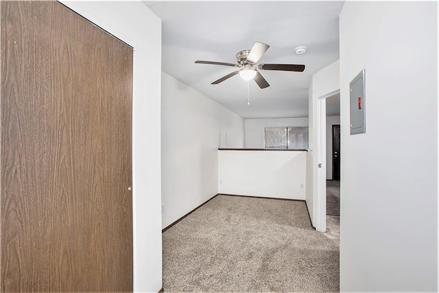 carpeted spare room with ceiling fan