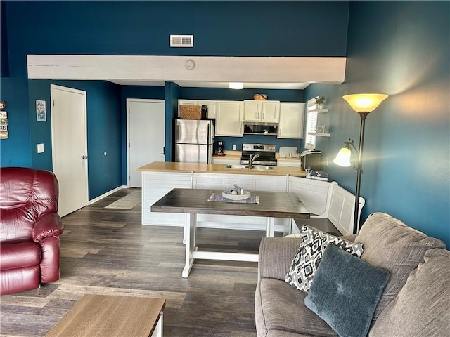 living room featuring dark hardwood / wood-style flooring and sink