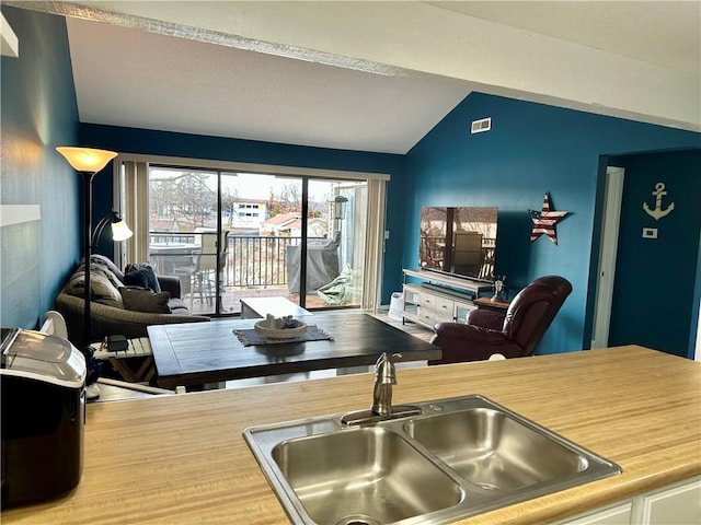 kitchen featuring sink and vaulted ceiling