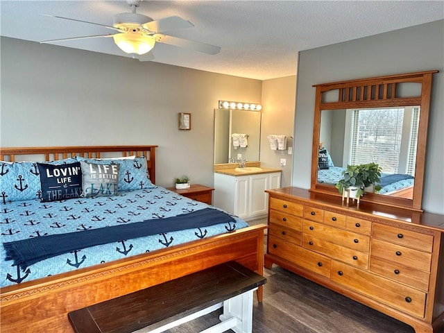 bedroom featuring ceiling fan, dark hardwood / wood-style floors, and sink