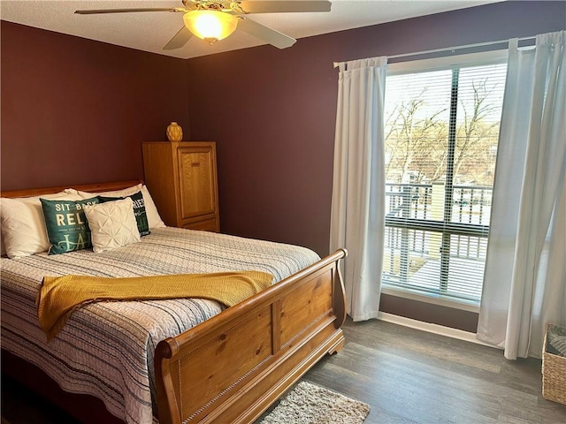 bedroom featuring ceiling fan and dark wood-type flooring