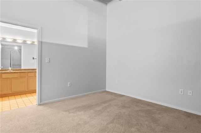 spare room featuring light colored carpet