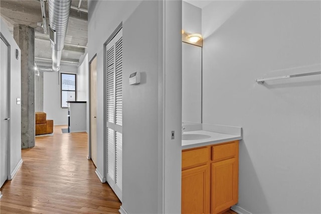 hall featuring light hardwood / wood-style floors and sink