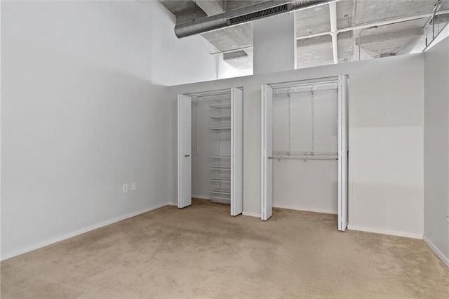 unfurnished bedroom featuring light colored carpet