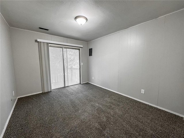 empty room featuring dark carpet