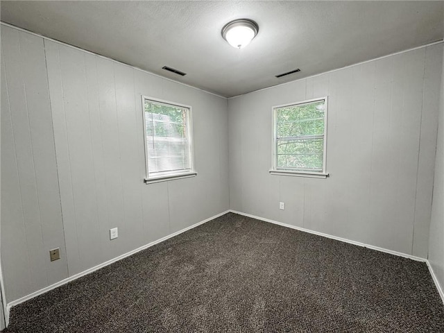 empty room with dark carpet